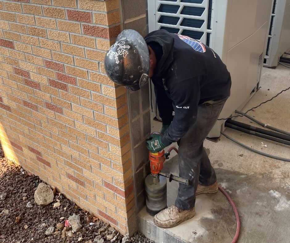 Concrete core drilling contractors creating a clean round opening on a commercial jobsite.