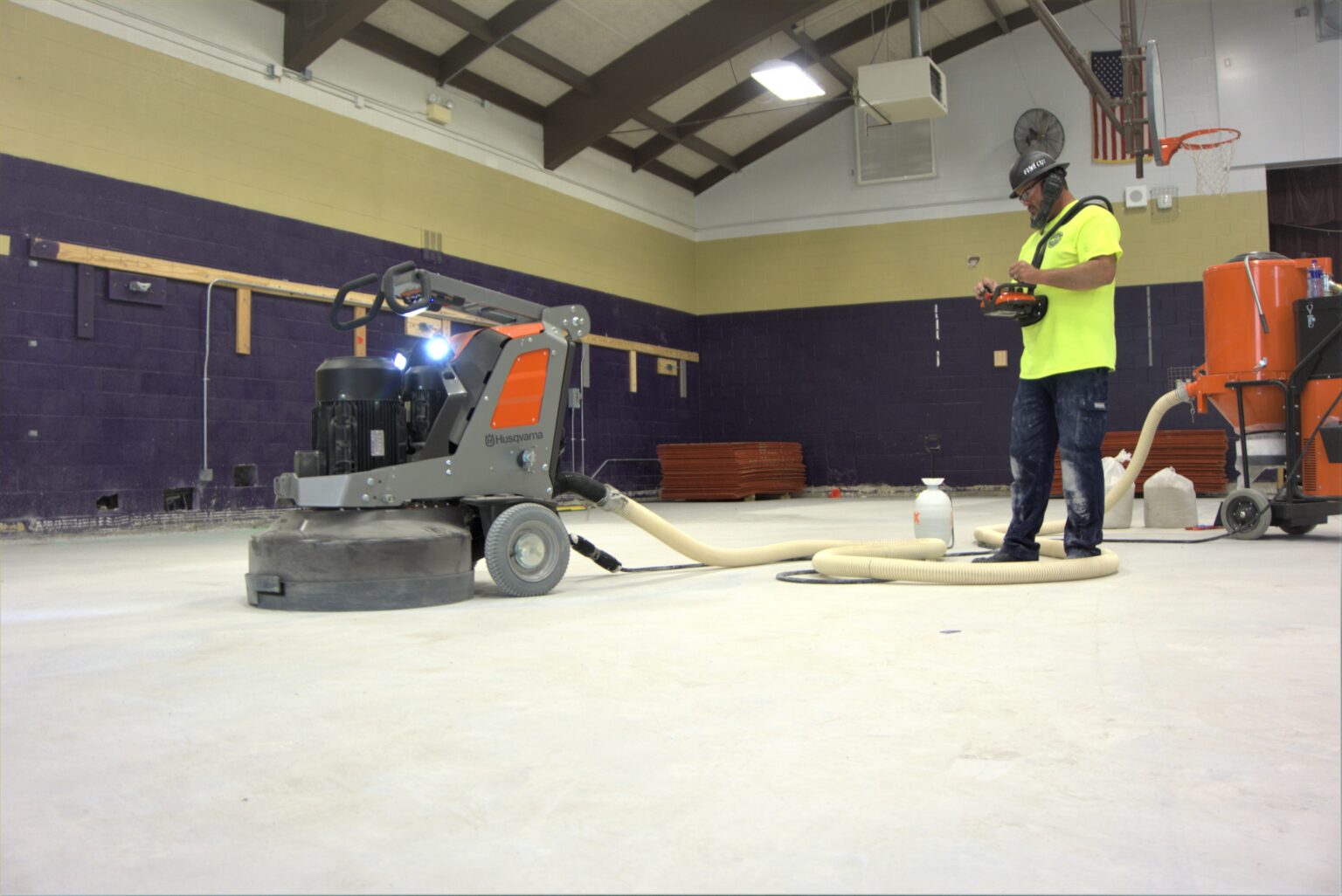 Fine Cut crew member grinding and polishing a high-traffic industrial concrete floor.